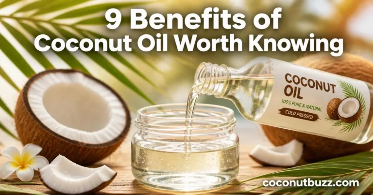 Glass jar and bottle of coconut oil with oil pouring surrounded by palm leaves and sliced coconuts on light wooden surface