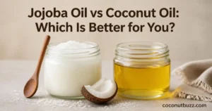 Two jars side by side with solid coconut oil and liquid jojoba oil with coconut shell piece on neutral soft background